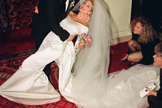 Donald Trump dips his new bride Marla Maples after couple married in a private ceremony at the Plaza Hotel, in New York, 20 December 1993, following a six-year courtship. Billionaire Donald Trump, who was born in 1946, Queens, New York, has gained notability for his celebrity lifestyle. He was previously married to Ivana Trump between 1977 and 1992. (Photo by BOB STRONG / AFP) (Photo by BOB STRONG/AFP via Getty Images)