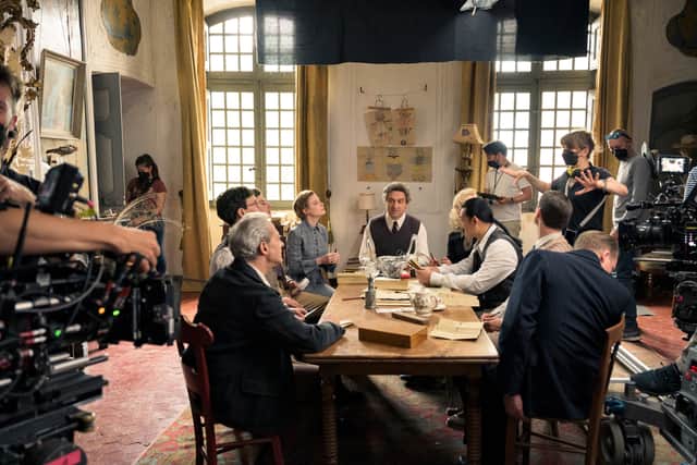 A behind the scenes photo from the set of Transatlantic, showing cast surrounded by crew and cameras (Credit: Netflix)