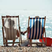 People sunbathe on Brighton Beach. Picture: GLYN KIRK/AFP via Getty Images