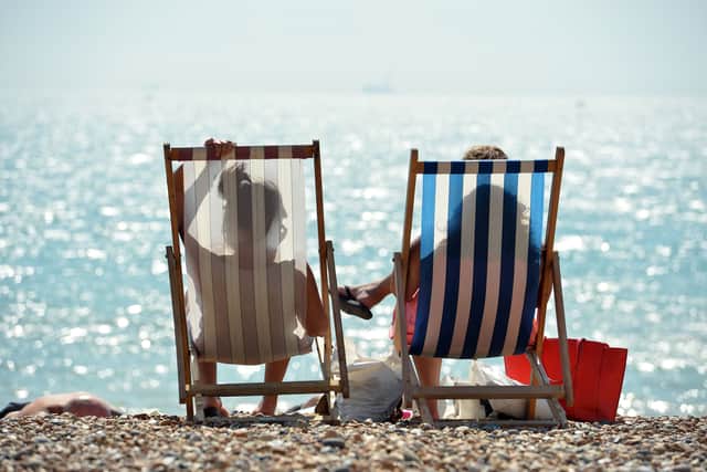 People sunbathe on Brighton Beach. Picture: GLYN KIRK/AFP via Getty Images