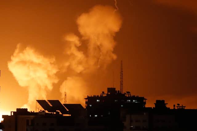 Smoke rises above buildings in Gaza City as Israel launches air strikes on the Palestinian enclave on late April 6, 2023 (Photo by MOHAMMED ABED / AFP) 