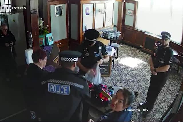 Video grab of the moment six cops stormed a couple’s pub and confiscated their golliwog  dolls from behind the bar. Picture: Benice Ryley / SWNS