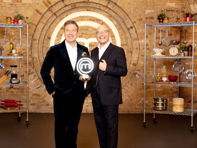 John Torrode and Gregg Wallace in the MasterChef kitchen, holding the MasterChef trophy (Credit: BBC/Shine UK)