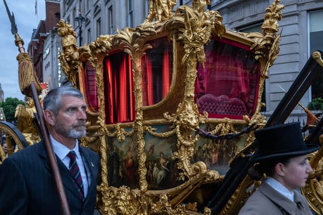 The Gold State Coach which carried HM Queen Elizabeth II at her Coronation is seen here featuring digitally displayed illuminated curtains during a rehearsal for the Queen's Platinum Jubilee pageant, on May 31, 2022 in London, England.