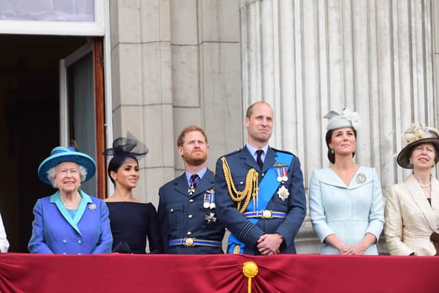Queen Elizabeth II, Meghan, Duchess of Sussex, Prince Harry, Duke of Sussex, Prince William Duke of Cambridge, Catherine, Duchess of Cambridge and Princess Anne, Princess Royal watch the RAF 100th anniversary flypast from the balcony of Buckingham Palace on July 10, 2018 in London, England. (Photo by Paul Grover - WPA Pool/Getty Images)