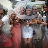 Racegoers brave the rain on Ladies Day at Grand National 