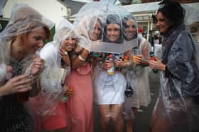 Racegoers brave the rain on Ladies Day at Grand National 