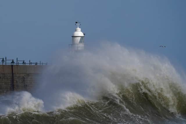 Waves crash around the lighthouse on the harbour arm in Folkestone (Photo: PA)