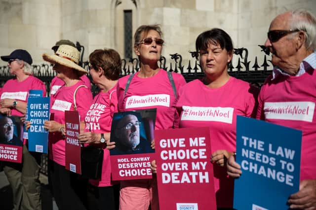 Supporters of Noel Conway from the campaign group Dignity in Dying stand with placards outside the Royal Courts of Justice, Strand on July 17, 2017 in London, England. (Photo by Jack Taylor/Getty Images)