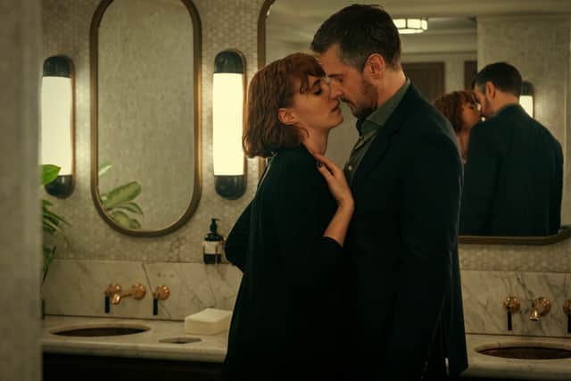 Charlie Murphy as Anna and Richard Armitage as William in Obsession, leaning into each other in a secret embrace (Credit: Netflix)