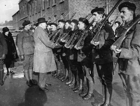 The Royal Irish Constabulary inspects a group of Black and Tans, an armed auxiliary force of the RIC, in 1921  (Photo by Topical Press Agency/Getty Images)