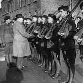 The Royal Irish Constabulary inspects a group of Black and Tans, an armed auxiliary force of the RIC, in 1921  (Photo by Topical Press Agency/Getty Images)