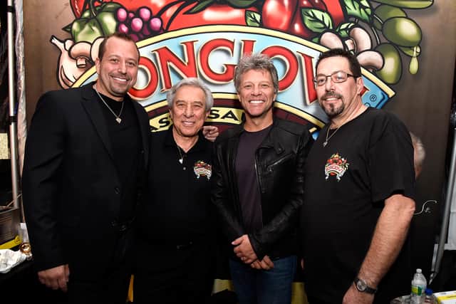 Matthew Bongiovi, John Francis Bongiovi Sr., Jon Bon Jovi, and Anthony Bongiovi pose at the Bongiovi Brand chef station at Ronzoni's La Sagra Slices hosted by Bongiovi Brand pasta sauces & Adam Richman presented by Time Out New York during the New York City Wine & Food Festival at Esurance Rooftop Pier 92 on October 16, 2014 in New York City.  (Photo by Larry Busacca/Getty Images for NYCWFF)