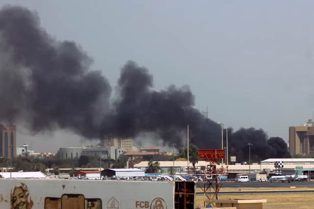 Heavy smoke bellows above buildings in the vicinity of the Khartoum’s airport on April 15. Picture: AFP via Getty Images