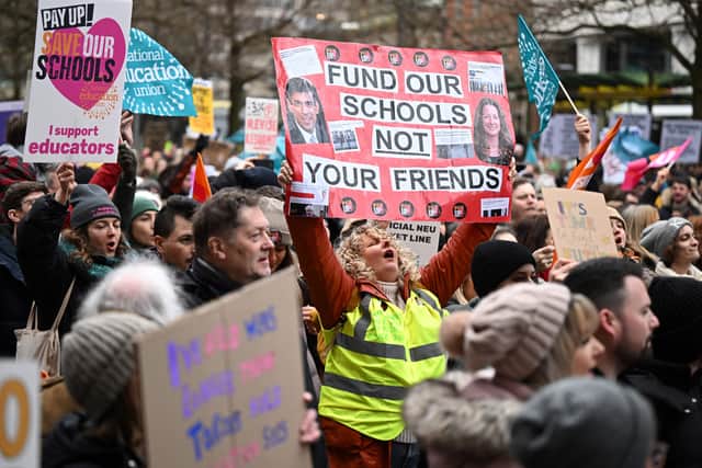 Teachers hold placards as they take part in a protest organised by the NEU and other affiliated trade unions in Manchester in February 2023 (Photo: OLI SCARFF/AFP via Getty Images)
