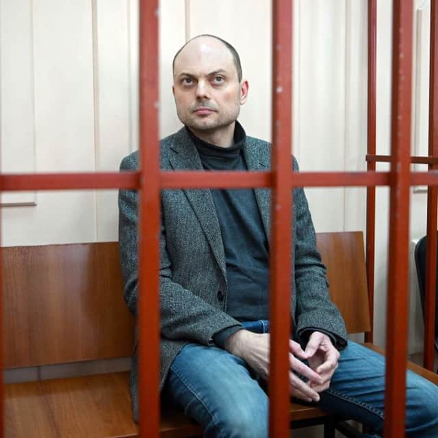Russian opposition activist Vladimir Kara-Murza sits on a bench inside a defendants' cage during a hearing last October (Photo by NATALIA KOLESNIKOVA / AFP) (Photo by NATALIA KOLESNIKOVA/AFP via Getty Images)