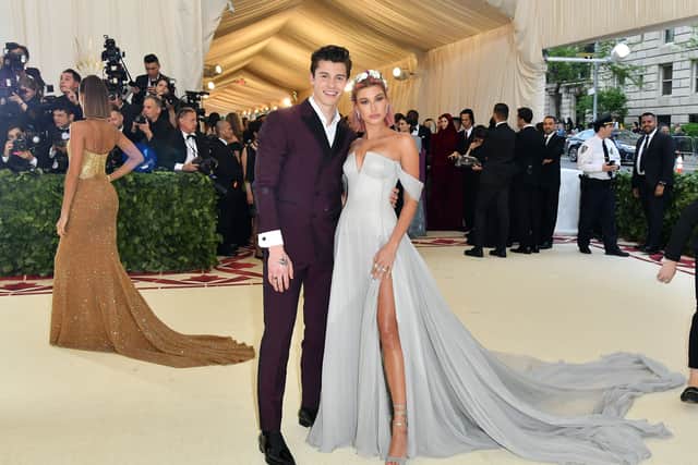 Shawn Mendez and Hailey Baldwin arrive for the 2018 Met Gala on May 7, 2018, at the Metropolitan Museum of Art in New York. - The Gala raises money for the Metropolitan Museum of Arts Costume Institute. The Gala's 2018 theme is Heavenly Bodies: Fashion and the Catholic Imagination. (Photo by ANGELA WEISS / AFP)        (Photo credit should read ANGELA WEISS/AFP via Getty Images)