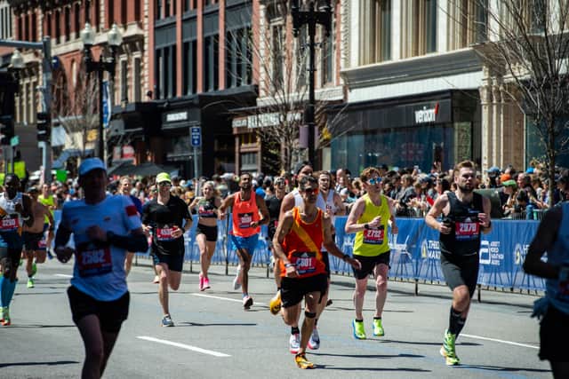 Runners make the final push down Boylston street to the finish line during the 126th Boston Marathon in Boston, Massachusetts on April 18, 2022. (Photo by JOSEPH PREZIOSO/AFP via Getty Images)