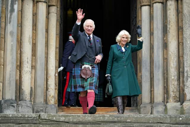 DUNFERMLINE, SCOTLAND - OCTOBER 03: King Charles III and Camilla, Queen Consort waves as they leave Dunfermline Abbey, after a visit to mark its 950th anniversary, and after attending a meeting at the City Chambers in Dunfermline where the King formally marked the conferral of city status on the former town on October 3, 2022 in Dunfermline, Scotland.  (Photo by  Andrew Milligan - Pool/Getty Images)