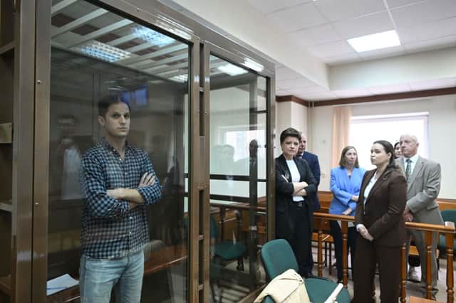 US journalist Evan Gershkovich, arrested on espionage charges, stands inside a defendants' cage before a hearing to consider an appeal on his arrest at the Moscow City Court in Moscow (Photo by NATALIA KOLESNIKOVA/AFP via Getty Images)