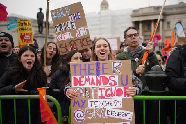 A young girl holds a banner in support of her teachers, during a strike rally in Trafalgar Square, central London. Picture date: Wednesday March 15, 2023. Credit: PA