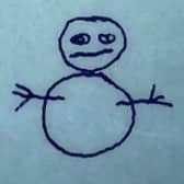 A crudely drawn snowman, underneath the words "Hello Mr Police", in The Snowman (Credit: Universal/Working Title)