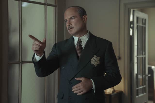 Liev Schreiber as Otto Frank in A Small Light, a yellowing Star of David sewn to his blazer (Credit: National Geographic for Disney/Dusan Martincek)