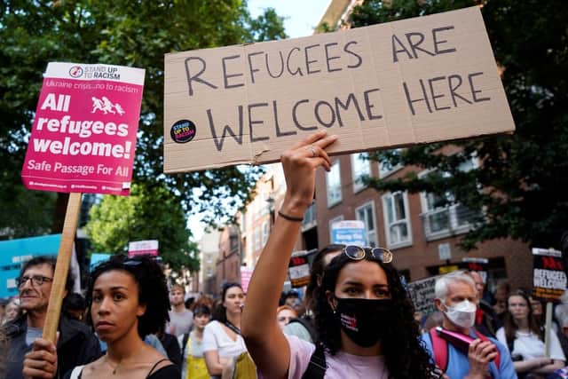 Protesters hold placards as they gather outside the Home Office in central London on June 13, 2022, to demonstrate against the UK Government’s intention to deport asylum-seekers to Rwanda. Credit: Getty Images