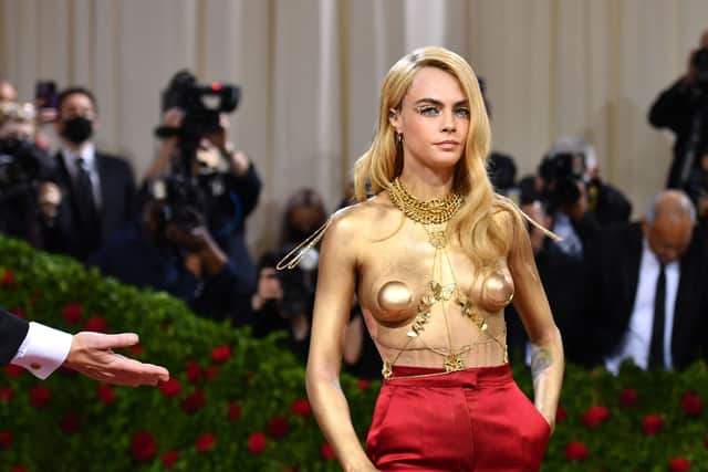 TOPSHOT - British model Cara Delevingne arrives for the 2022 Met Gala at the Metropolitan Museum of Art on May 2, 2022, in New York. - The Gala raises money for the Metropolitan Museum of Art's Costume Institute. The Gala's 2022 theme is "In America: An Anthology of Fashion". (Photo by ANGELA WEISS / AFP) (Photo by ANGELA WEISS/AFP via Getty Images)