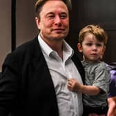 Twitter CEO Elon Musk holds one of his children after a keynote speech at the "Twitter 2.0: From Conversations to Partnerships," marketing conference in Miami Beach, Florida, on April 18, 2023. (Photo by CHANDAN KHANNA / AFP) (Photo by CHANDAN KHANNA/AFP via Getty Images)