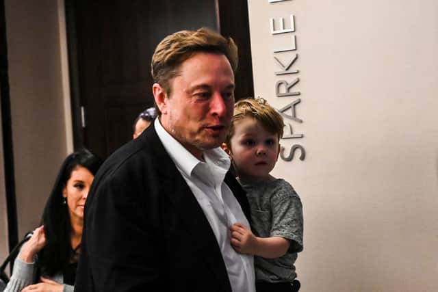 Twitter CEO Elon Musk holds one of his children after a keynote speech at the "Twitter 2.0: From Conversations to Partnerships," marketing conference in Miami Beach, Florida, on April 18, 2023. (Photo by CHANDAN KHANNA/AFP via Getty Images)