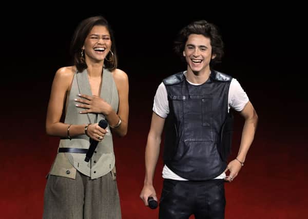 LAS VEGAS, NEVADA - APRIL 25: (L-R) Zendaya and Timothee Chalamet speak on stage as they promote the upcoming film "Dune: Part Two" during the Warner Bros. Pictures Studio presentation during CinemaCon, the official convention of the National Association of Theatre Owners, at The Colosseum at Caesars Palace on April 25, 2023 in Las Vegas, Nevada. (Photo by Ethan Miller/Getty Images)