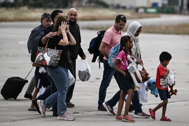 Greek nationals from Sudan arrive with a military C-27 plane at the military airport of Elefsina, south of Athens (Photo: ARIS MESSINIS/AFP via Getty Images)