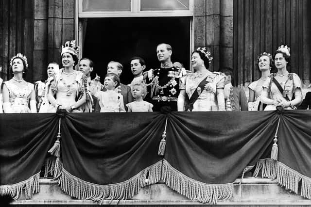 Prince Charles stands next to his mother, Queen Elizabeth II, on the Buckingham Palace balcony following her coronation in 1953
