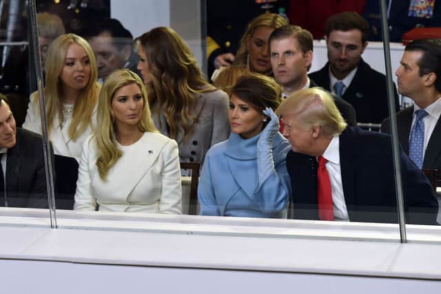 US President Donald Trump is joined by US First Lady Melania Trump (2nd R front), his daughter Ivanka Trump (2nd L front) and her husband Jared Kushner (L front) during the presidential inaugural parade  on January 20, 2017 in Washington, (Photo credit should read NICHOLAS KAMM/AFP via Getty Images)