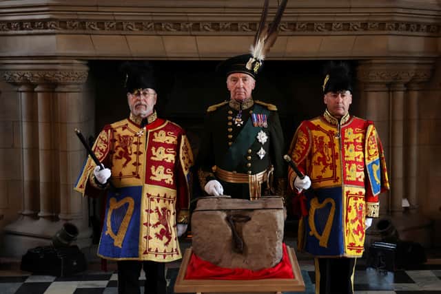 The Duke of Buccleuch Richard Scott (C), flanked by two Officers of Arms, stands by the Stone of Destiny during a special ceremony at Edinburgh Castle on 27 April 2023 before it is transported to Westminster Abbey for the Coronation of King Charles III (Photo: RUSSELL CHEYNE/POOL/AFP via Getty Images)