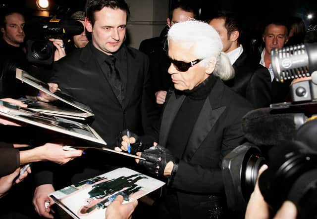 Karl Lagerfeld signs autographs as he leaves the Lagerfeld Confidential Party during the 57th Berlin International Film Festival (Berlinale) on February 10, 2007 in Berlin, Germany. (Photo by Pascal Le Segretain/Getty Images)
