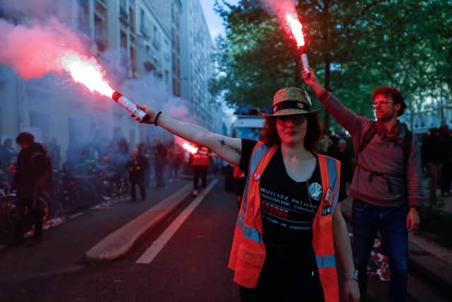 Demonstrators from the General Confederation of Labour (CGT) hold flares during this year’s May Day protests in Paris, France (Photo: Ameer Alhalbi/Getty Images)