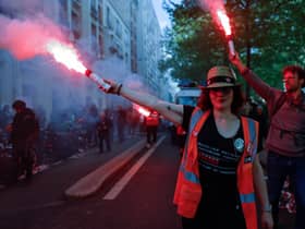 Demonstrators from the General Confederation of Labour (CGT) hold flares during this year’s May Day protests in Paris, France (Photo: Ameer Alhalbi/Getty Images)