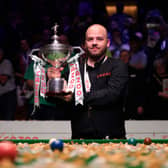 Luca Brecel lifts his World Championship trophy