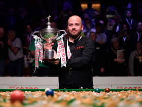 Luca Brecel lifts his World Championship trophy