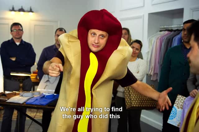Tim Robinson in I Think You Should Leave, wearing a hot dog costume, with the text "We're all trying to find the guy who did this" along the bottom of the image (Credit: Netflix)