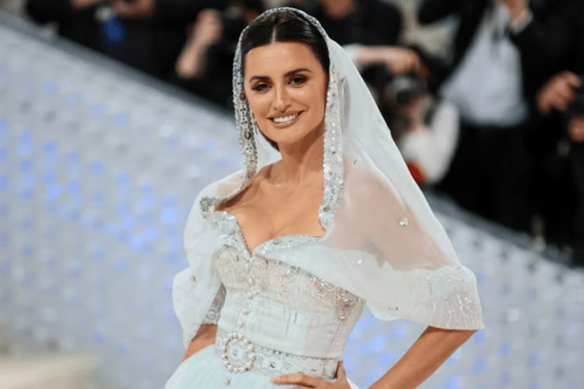 Penelope Cruz boasted a sheer white gown adored with silver sequins and had a hood attached to it - Credit: Getty