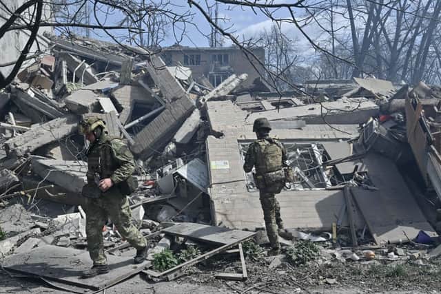 Members of the Ukrainian White Angels Special Police Team look at debris of a residential building, destroyed following an air strike in the frontline town of Avdiivka, Donetsk region on April 10, 2023, amid the Russian invasion of Ukraine. Credit: Getty Images