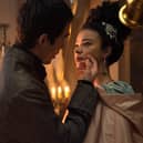 Corey Mylchreest as Young King George and India Amarteifio as Young Queen Charlotte in Queen Charlotte: A Bridgerton Story. He brushes her face as they turn away from his telescope (Credit: Liam Daniel/Netflix)