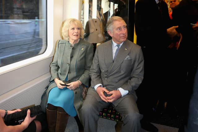 Britain's Prince Charles (Seated R) and his wife Camilla, Duchess of Cornwall (Seated L) travel on a Metropolitan underground train from Farringdon to London's Kings Cross as they mark 150 years of the London Underground on January 30, 2013. The London Underground was the world's first underground railway, then known as the Metropolitan Railway, unveiled its first stretch of track between Paddington and Farringdon on January 9, 1863, with passengers making their first journeys a day later. AFP PHOTO / CHRIS JACKSON/POOL (Photo by Chris Jackson / POOL / AFP) (Photo by CHRIS JACKSON/POOL/AFP via Getty Images)