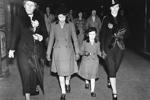 British Princesses Elizabeth (second left) and Margaret are accompanied by Lady Helen Graham (left) and governess Marion Kirk Crawford (right) as they arrive for their first ride on an London Underground 'tube' train at St James's Park, London, May 15th 1939. (Photo by Central Press/Hulton Archive/Getty Images)