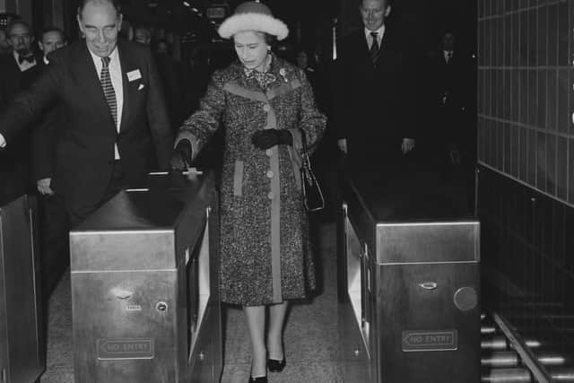 Queen Elizabeth II passing though the tube gates at Heathrow Central, London, UK, 16th December 1977. (Photos by Maurice Hibberd/Evening Standard/Hulton Archive/Getty Images)
