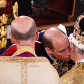 Prince William, Prince of Wales kisses his father, King Charles III, wearing St Edward's Crown, during the King's Coronation Ceremony inside Westminster Abbey on May 6, 2023 in London, England. The Coronation of Charles III and his wife, Camilla, as King and Queen of the United Kingdom of Great Britain and Northern Ireland, and the other Commonwealth realms takes place at Westminster Abbey today. Charles acceded to the throne on 8 September 2022, upon the death of his mother, Elizabeth II. (Photo by Yui Mok  - WPA Pool/Getty Images)