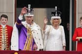 The King and Queen greet crowds from the Buckingham Palace balcony. Credit: PA